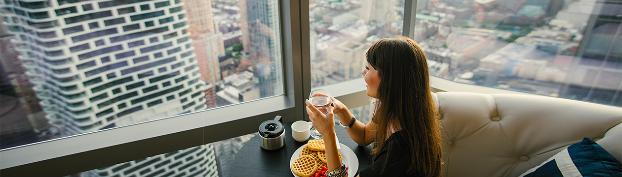 Women have breakfast by amazing city view