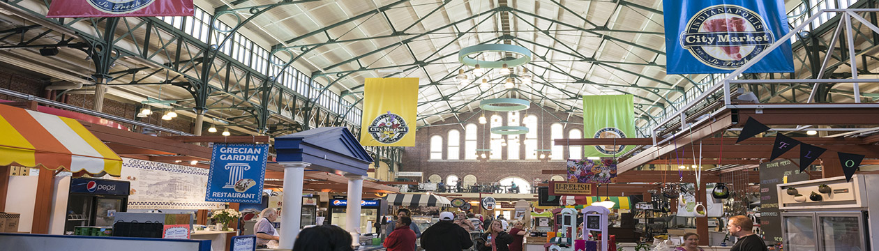 Indianapolis, Indiana, USA - April 10, 2015: People walk past food stalls and shops inside City Market in Indianapolis, Indiana. Founded in 1821, the Indianapolis City Market opened in its current facility in 1886.