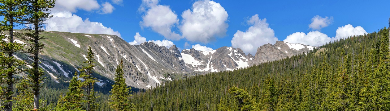 South Saint Vrain Creek at Long Lake, with Indian Peaks towering in background, on a sunny Spring morning. Indian Peaks Wilderness, Colorado, USA.