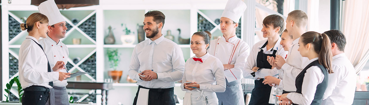 Restaurant manager and his staff in terrace. interacting to head chef in restaurant