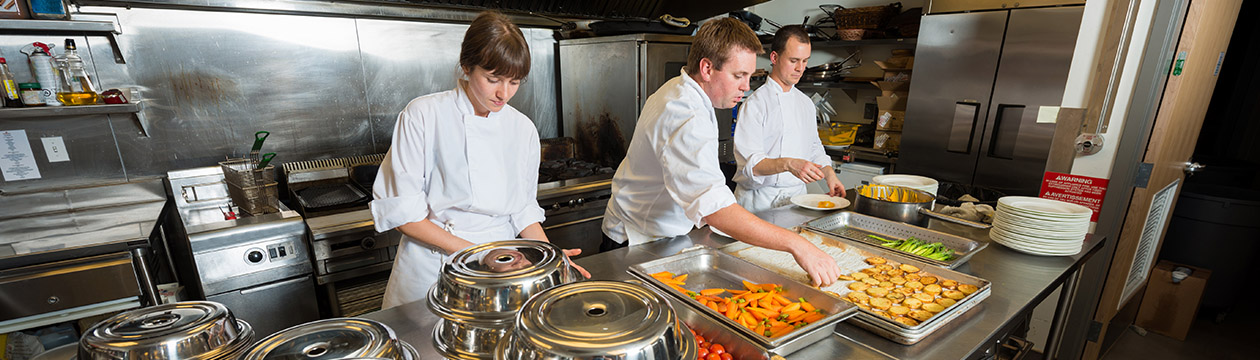 Chef`s dishing up a main course
